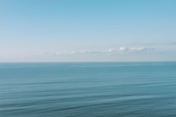 Obraz premium Calm ocean waves in serene blue tones with soft natural lighting for tranquil seascape background