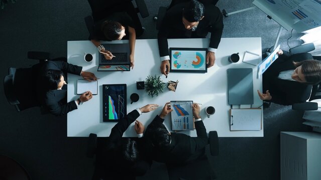 Time lapse of diverse marketing team prepare for business meeting. Top down aerial view of businesspeople placed laptop and tablet with financial statistic at table. Creative business. Directorate. - Powered by Adobe