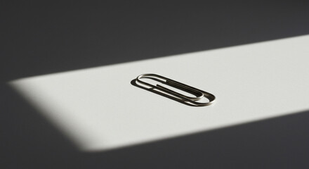 Small metallic cylinder on plain background close up