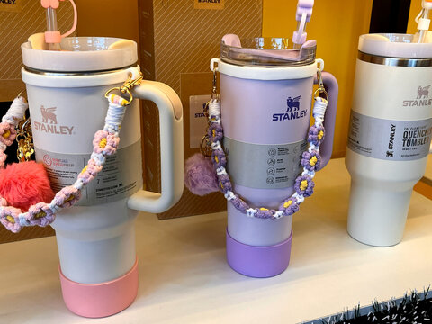 Da nang, Vietnam - January, 11, 2026: Three stylish Stanley drink tumblers are displayed on a table. The colors include pastel pink, lavender, and off-white.