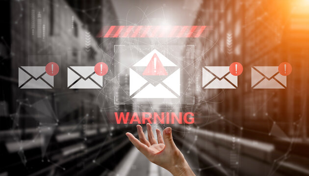 A hand reaches out towards floating email icons marked with warnings in a digital environment, emphasizing the importance of cybersecurity and awareness of potential threats. Gantry - Powered by Adobe