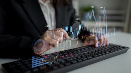 A businessperson engages in financial analysis, inputting data on a computer keyboard while observing digital graphs on a modern office background, highlighting investment trends. Scalp