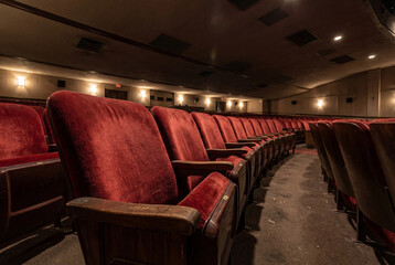 old cinema interior with red velvet chairs