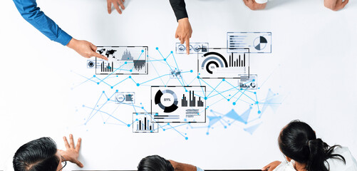 A diverse business team collaborates over data analysis, showcasing modern charts and graphs in a digital workspace that emphasizes teamwork and strategy. Trope