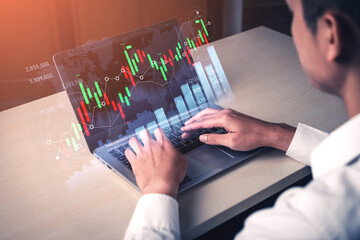 A business professional uses a laptop to analyze financial market data through innovative graphs and charts, symbolizing the intersection of technology and finance. Scalp