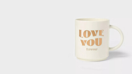Golden LOVE YOU Forever stonewear mug on copy-space background.