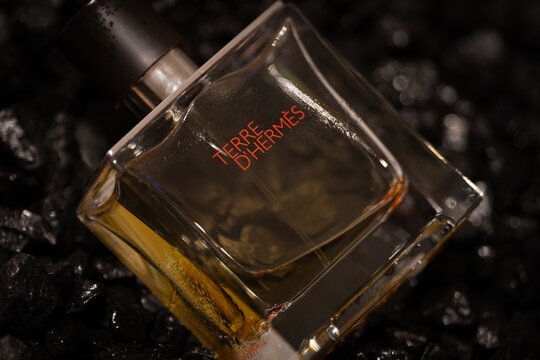 Bucharest Romania 19 January 2026. Moody still life of a men&rsquo;s perfume bottle set between black stones. Dark tones and minimal composition symbolizing mystery, power, and refinement.