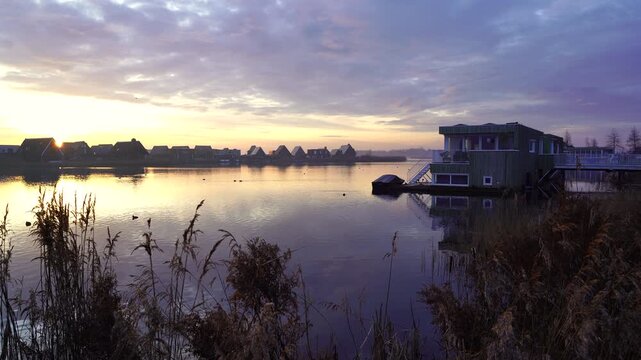 A colourful dawn in modern neighbourhood at the waterfront. Meerstad, the Netherlands