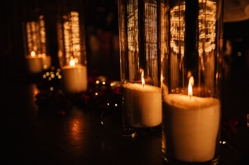 Candlelight date in restaurant. Table setting for couple, Valentine's Day evening, burning candles for surprise marriage proposal. Romantic dinner setup at night.