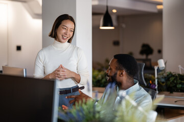 Diverse colleagues collaborating discussing business in office environment