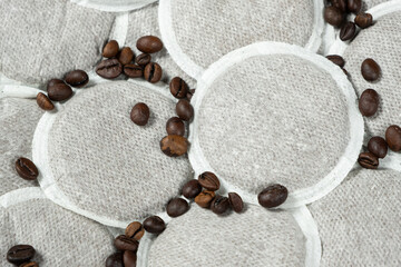 Coffee pads for brewing coffee in the coffee machine and scattering coffee beans © Zarina Lukash