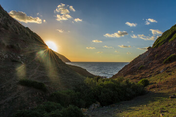 Island in the Mediterranean Sea, sea with clear blue water on a sunny day with beautiful sky and sunset clouds, summer background concept, holiday on beach coast and swimming in Jijel Algeria, Africa.