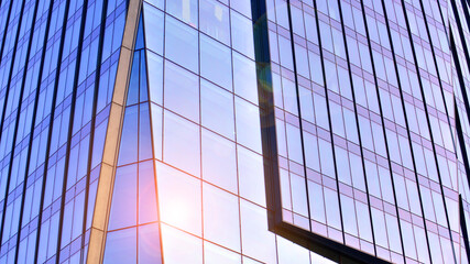 Fototapeta premium Modern office building exterior made from glass and steel. Windows of office building. Abstract architectural concept with sunlight. 