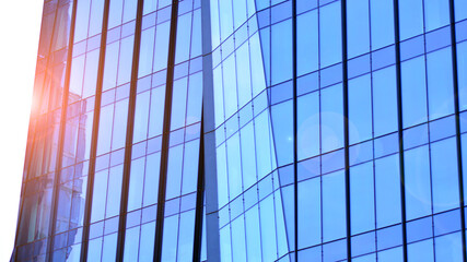 Fototapeta premium Modern office building exterior made from glass and steel. Windows of office building. Abstract architectural concept with sunlight. 