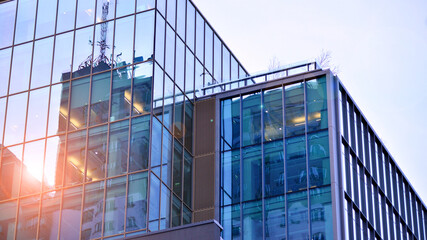 Modern office building exterior made from glass and steel. Windows of office building. Abstract architectural concept with sunlight. 