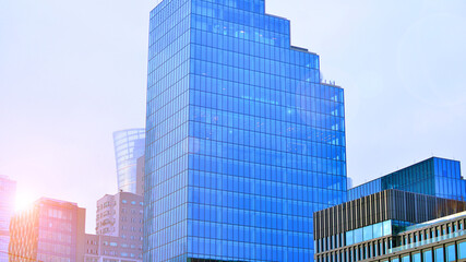 Obraz premium Modern office building exterior made from glass and steel. Windows of office building. Abstract architectural concept with sunlight. 