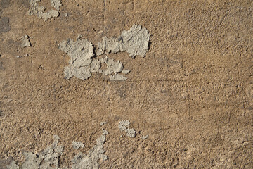 An old painted wall with peeling paint as a background.