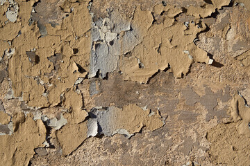 An old painted wall with peeling paint as a background.