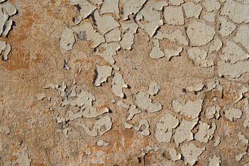 An old painted wall with peeling paint as a background.
