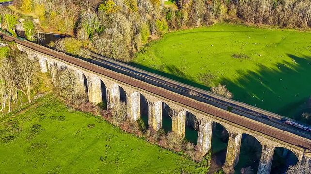 A receding aerial view flying away from close to the Chirk viaduct in Wrexham, Wales