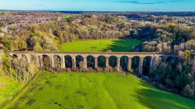 A receding aerial view flying away from the Chirk viaduct in Wrexham, Wales