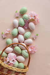 Easter Basket with Pastel Eggs, Flowers and Bunny Decorations. Festive Spring Flatlay
