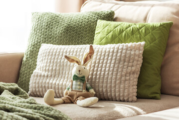 Cozy Sofa with Plush Easter Bunny Doll and Textured Pillows in Sunlight