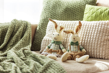 Cozy Sofa with Plush Easter Bunny Dolls and Textured Pillows in Sunlight
