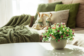 Cozy Easter Living Room with Plush Easter Bunny Dolls and Spring Flowers on Table