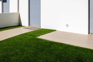 Fototapete Rund Mediterranes Europa Minimalist residential building entrance with white facade roller shutters tiled walkway and green artificial grass in a modern coastal town, Portugal, Torreira, 13 October 2025  © were