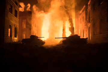 Fototapeta premium War Concept. Military silhouettes fighting scene on war fog sky background, World War Soldiers Silhouette Below Cloudy Skyline At night. Battle in ruined city.