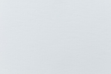 Delicate texture of an unexposed fiber-based bromide photo paper. Traditional baryta photopaper used for analog black-and-white silver prints.