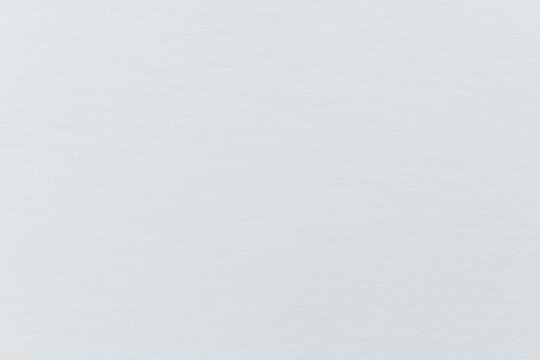 Delicate texture of an unexposed fiber-based bromide photo paper. Traditional baryta photopaper used for analog black-and-white silver prints.