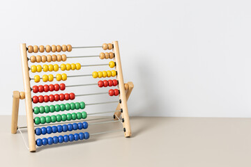 Colorful wooden abacus on table developing childhood math skills and learning. Copy space