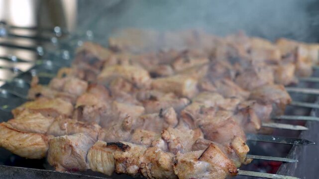 Traditional georgian mtsvadi, grill on the coals with smoke. Shashlik, barbecue. Slow motion
