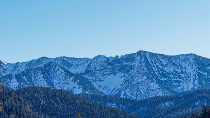The snow-capped Hinteres Sonnwendjoch, the highest peak of the Mangfall in AustrianTyrol seen from Lake Spitzingsee in the Bavarian Alps
