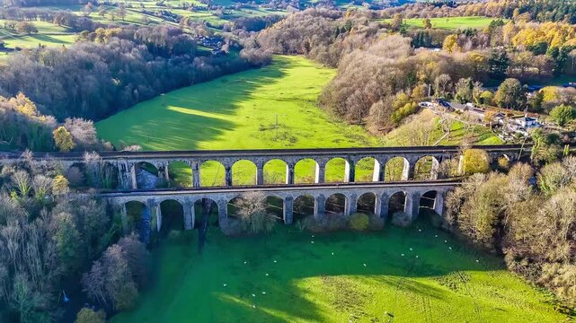 A receding aerial view flying away from the south side of the viaduct and aqueduct at Chirk, Wrexham, Wales