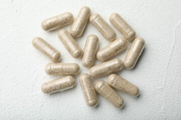 Gelatin capsules on white table, flat lay