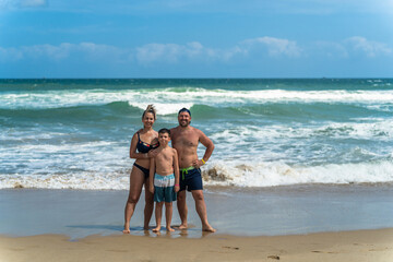 Beautiful young family on vacation at sea