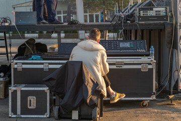 sound engineer in front of the stage works with sound.