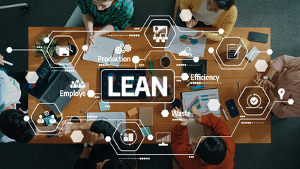 Aerial view of a team collaborating on lean methodology strategies, showcasing charts and discussions aimed at improving efficiency and reducing waste in the workplace. Amity
