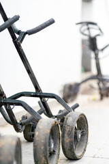 Two golf carts are parked next to each other