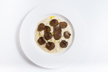 Plate of Italian risotto with truffle on a white background. Top view.