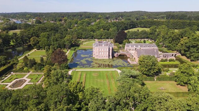 brick facade flanked by outbuildings within square lily covered moat gardens woodland middachten castle netherlands long aerial drone view manor house lily-covered 