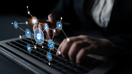 A person types on a laptop surrounded by digital connectivity icons, representing modern business communication and innovative strategies in a professional setting. Tessel