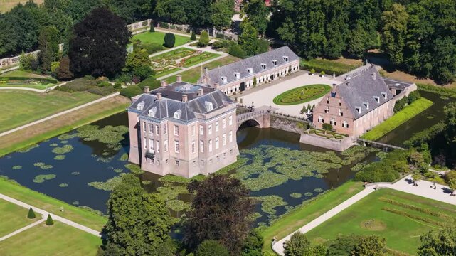 historic castle framed by outbuildings lily covered moat middachten estate netherlands long up close wide aerial view lily-covered gelderland 