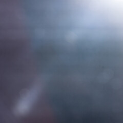 Abstract dark blue and grey bokeh background with soft moody light gradients