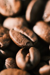 Close-up macro shot of roasted coffee beans with rich brown tones and textured surfaces © Kirill