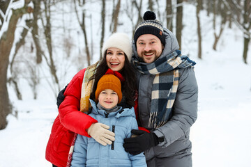 Happy family having fun together outdoors on winter day
