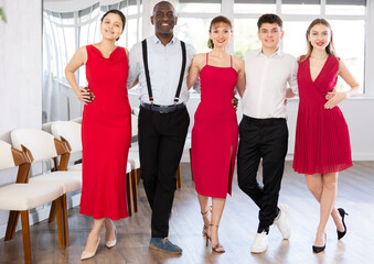 Fototapeta premium Group of multiethnic men and women dancers posing in dance studio